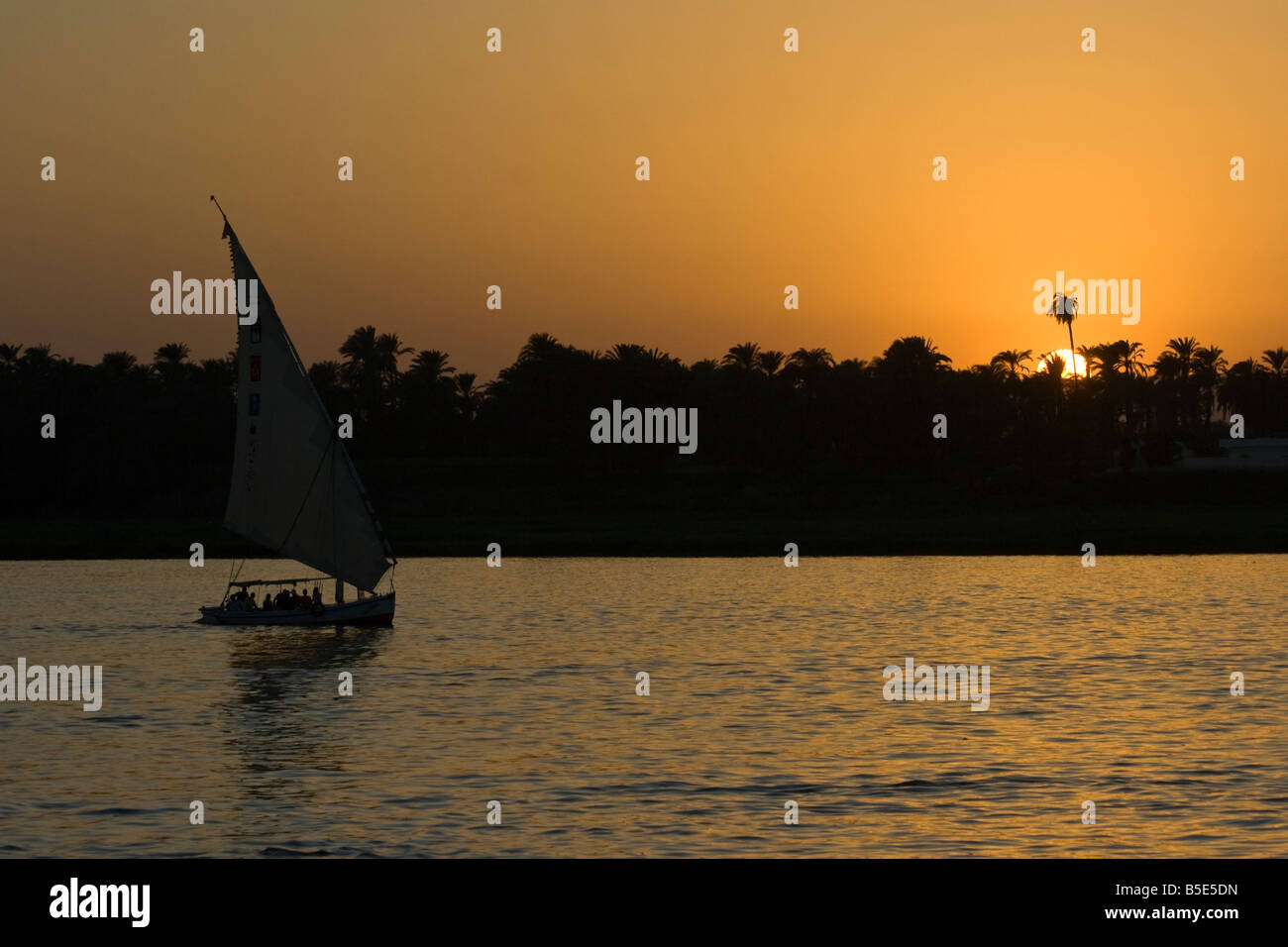 Felucca Sailboat at Sunset on the Nile River in Luxor Egypt Stock Photo