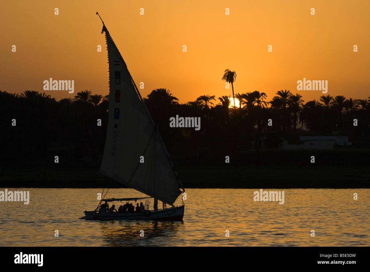 Felucca Sailboat at Sunset on the Nile River in Luxor Egypt Stock Photo