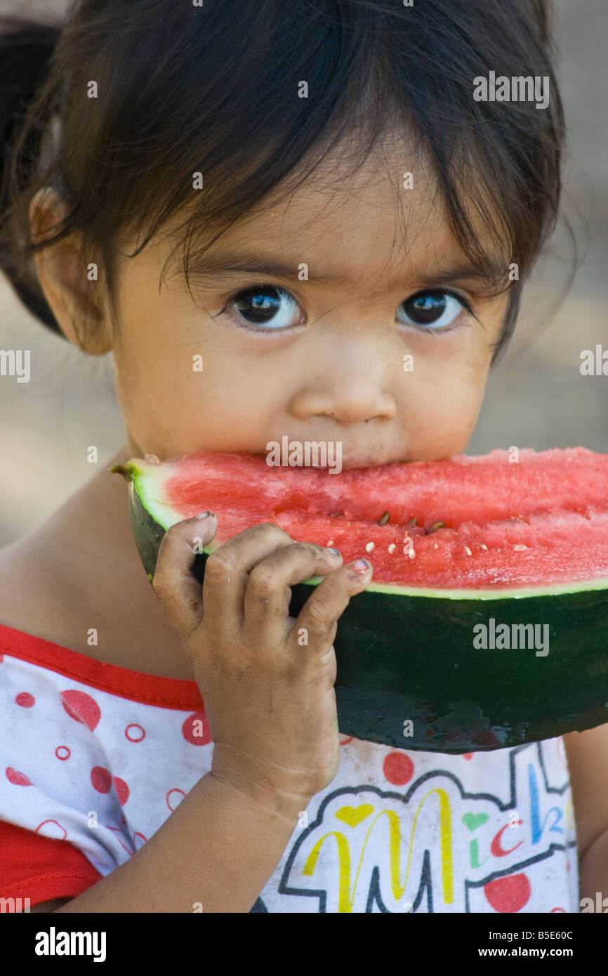 Young Girl Eating Watermelon on Gili Trawangan off Lombok Island in Indonesia Stock Photo