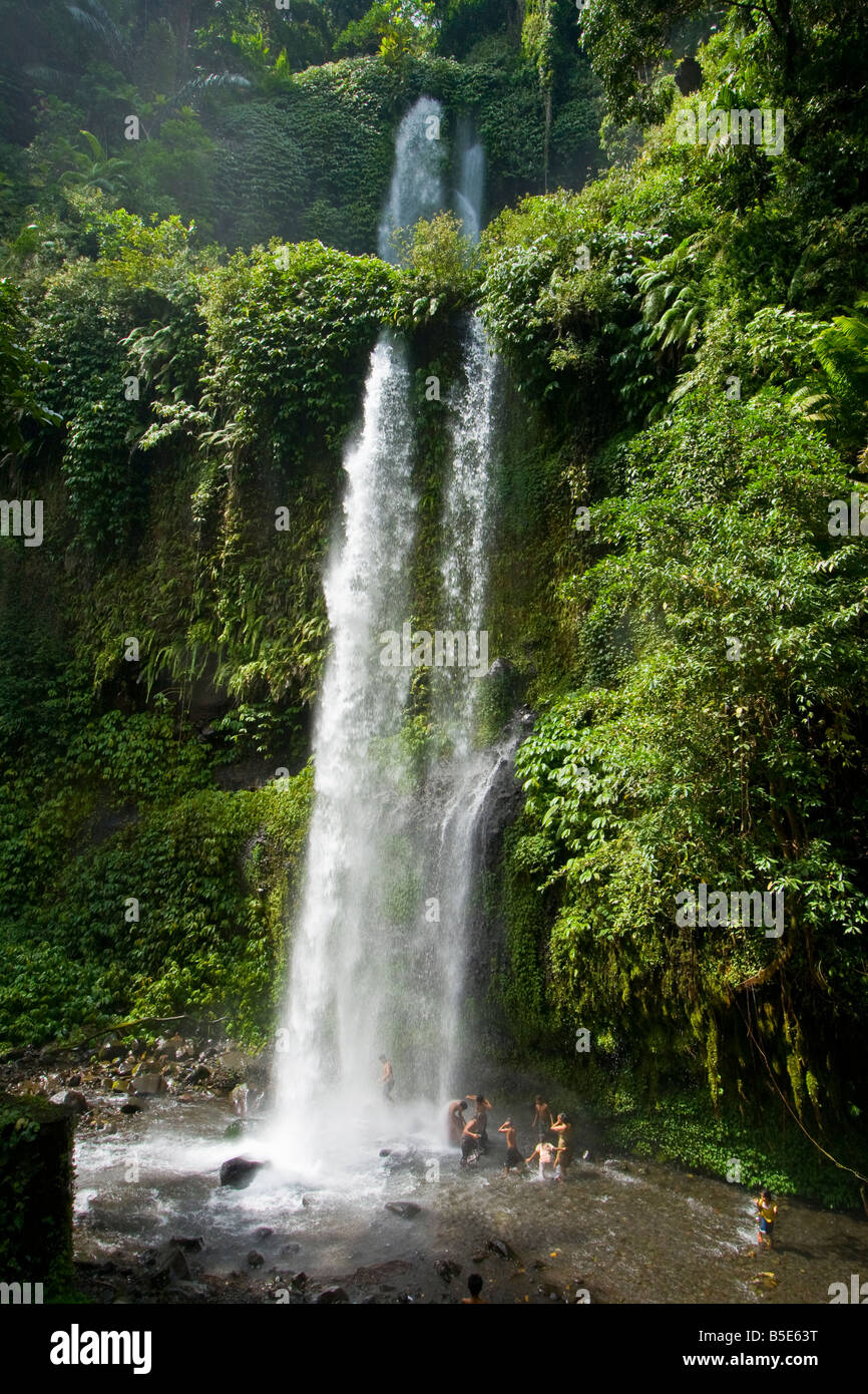 Local People Under Sindang Gila Waterfall in Senaru on Lombok Island in Indonesia Stock Photo