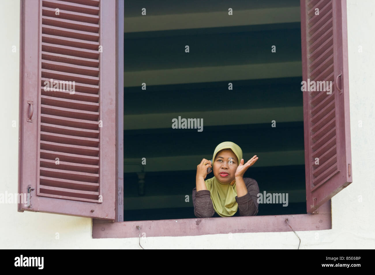 Indonesian Woman Using a Mobile Phone in Fort Rotterdam in Makassar on Sulawesi in Indonesia Stock Photo