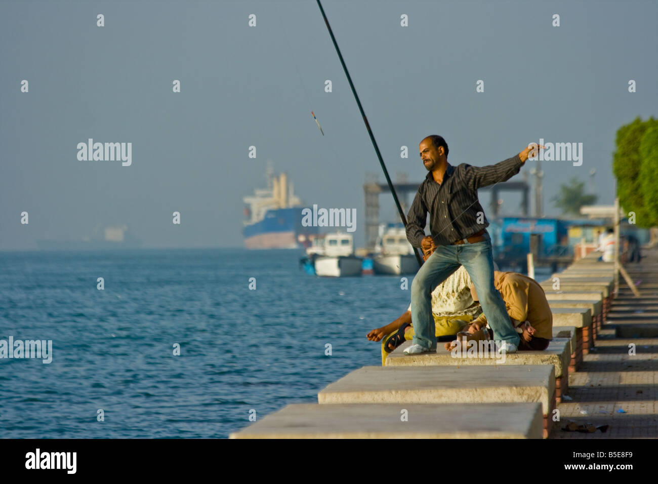 Man Fishing in the Suez Canal in Suez Egypt Stock Photo: 20597677 - Alamy