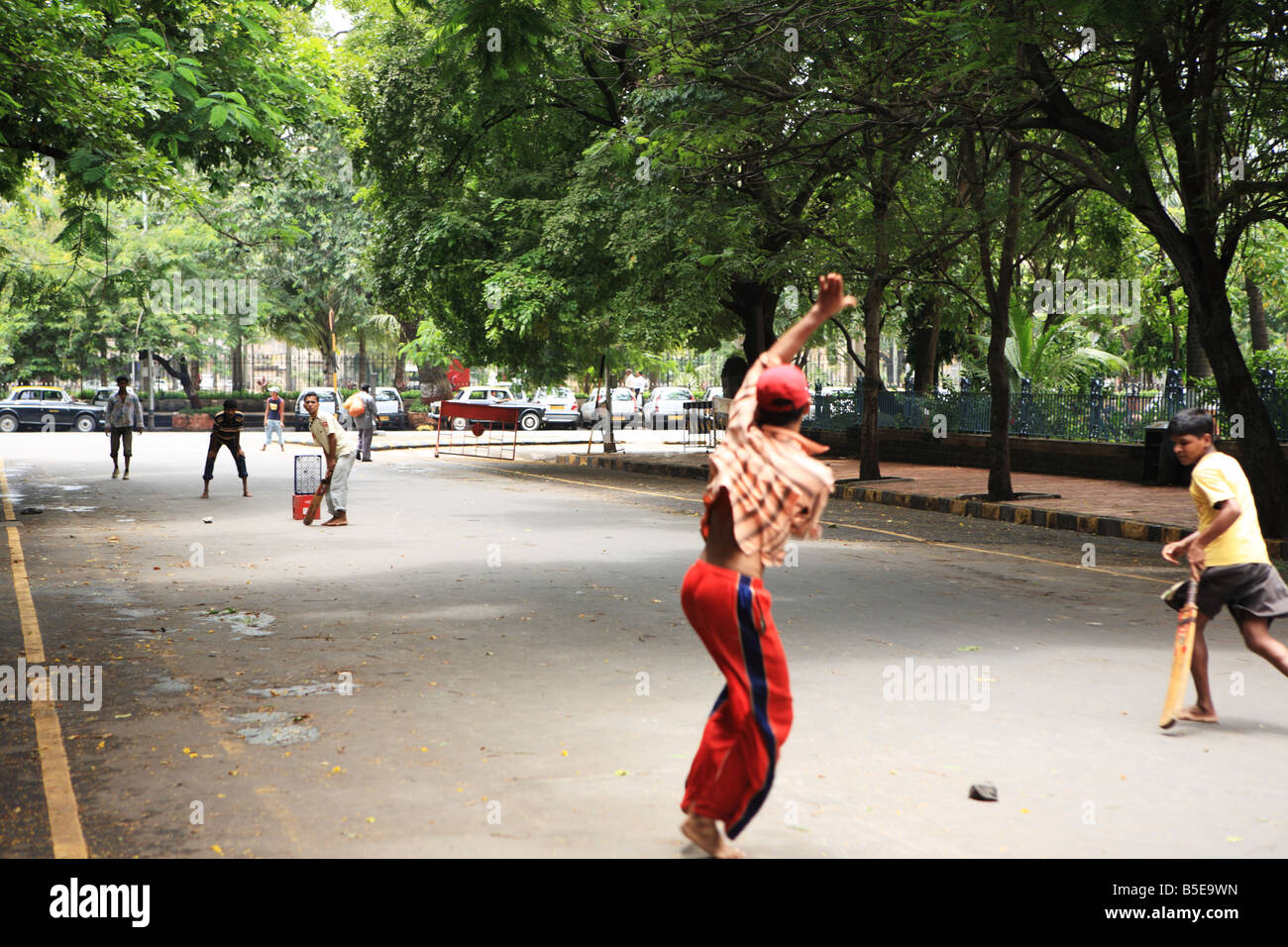 Boys playing street cricket Mumbai, India Stock Photo