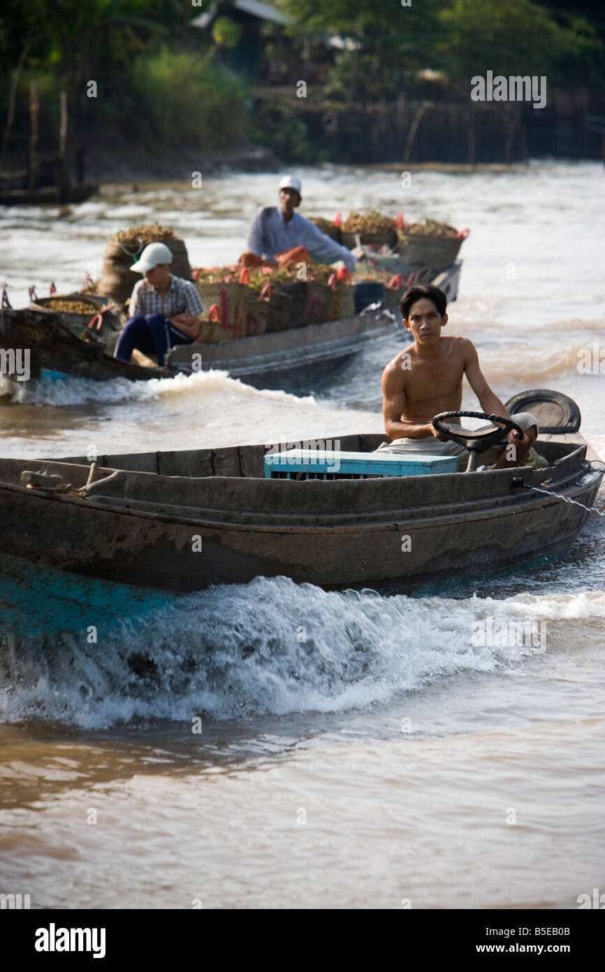 Boat traffic in the Mekong Delta close to Vinh Long VIetnam Stock Photo