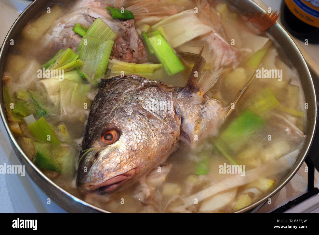 The typical Vietnamese sour fish head soup ( canh chua dau ca ) Stock Photo
