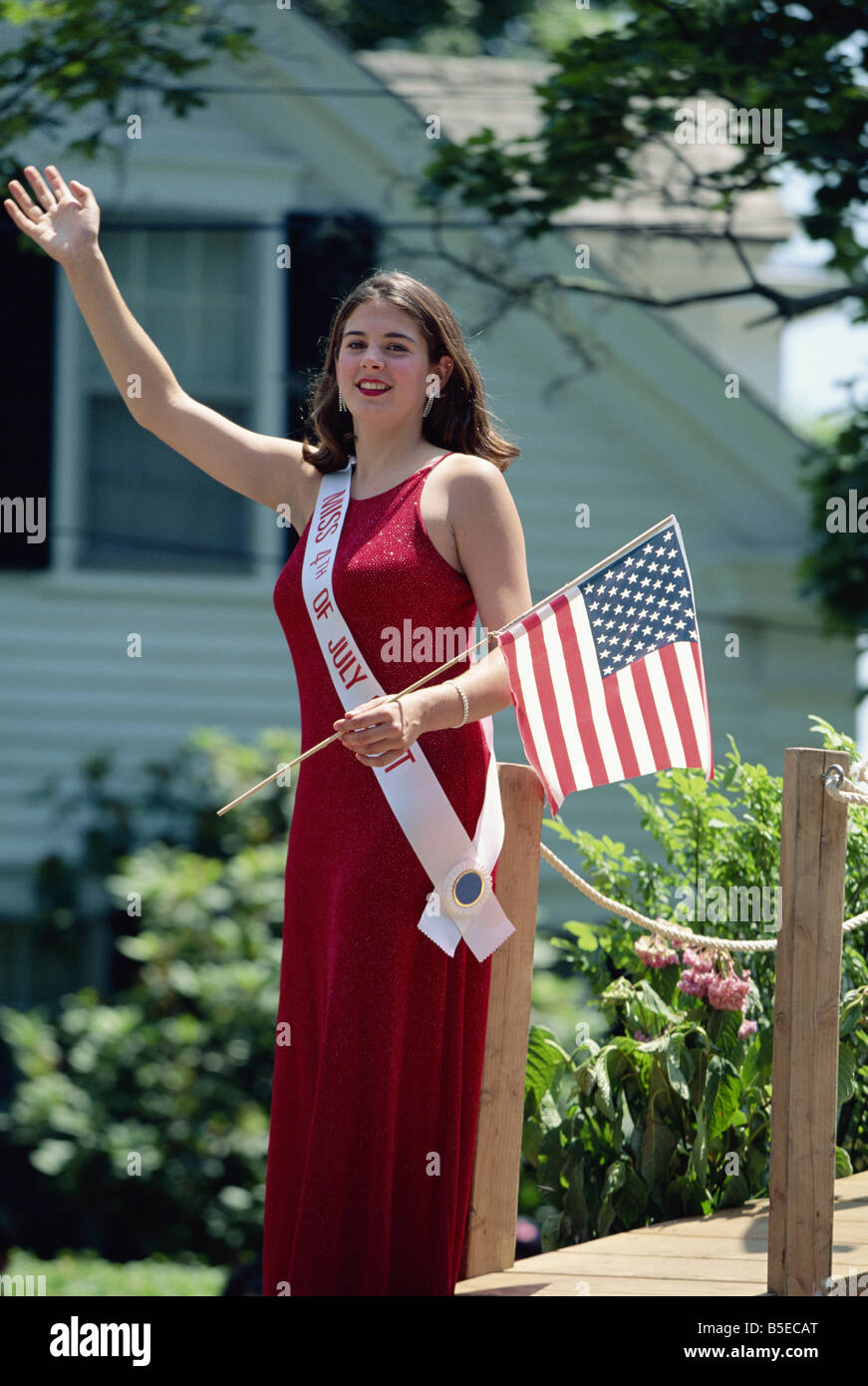 Fourth of July beauty queen with Stars and Stripes flag, waving to parade, Rhode Island, New England, USA, North America Stock Photo