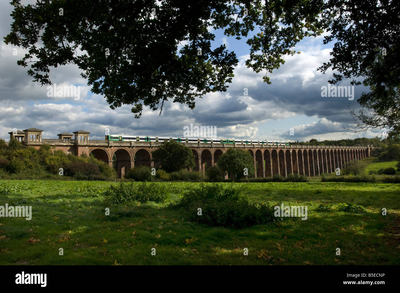 A Southern Railways Brighton to London commuter express train crosses the Ouse Valley Viaduct Balcombe Stock Photo