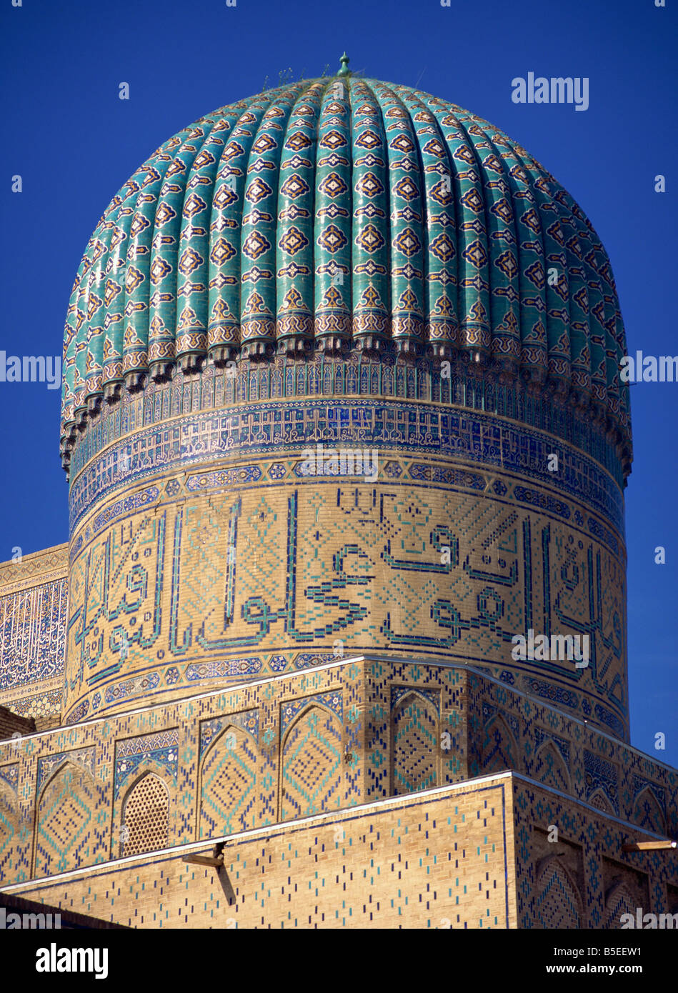 The ribbed dome, tiles and Arabic script on the Bibi Khanym Mosque in Samarkand, Uzbekistan, Central Asia Stock Photo