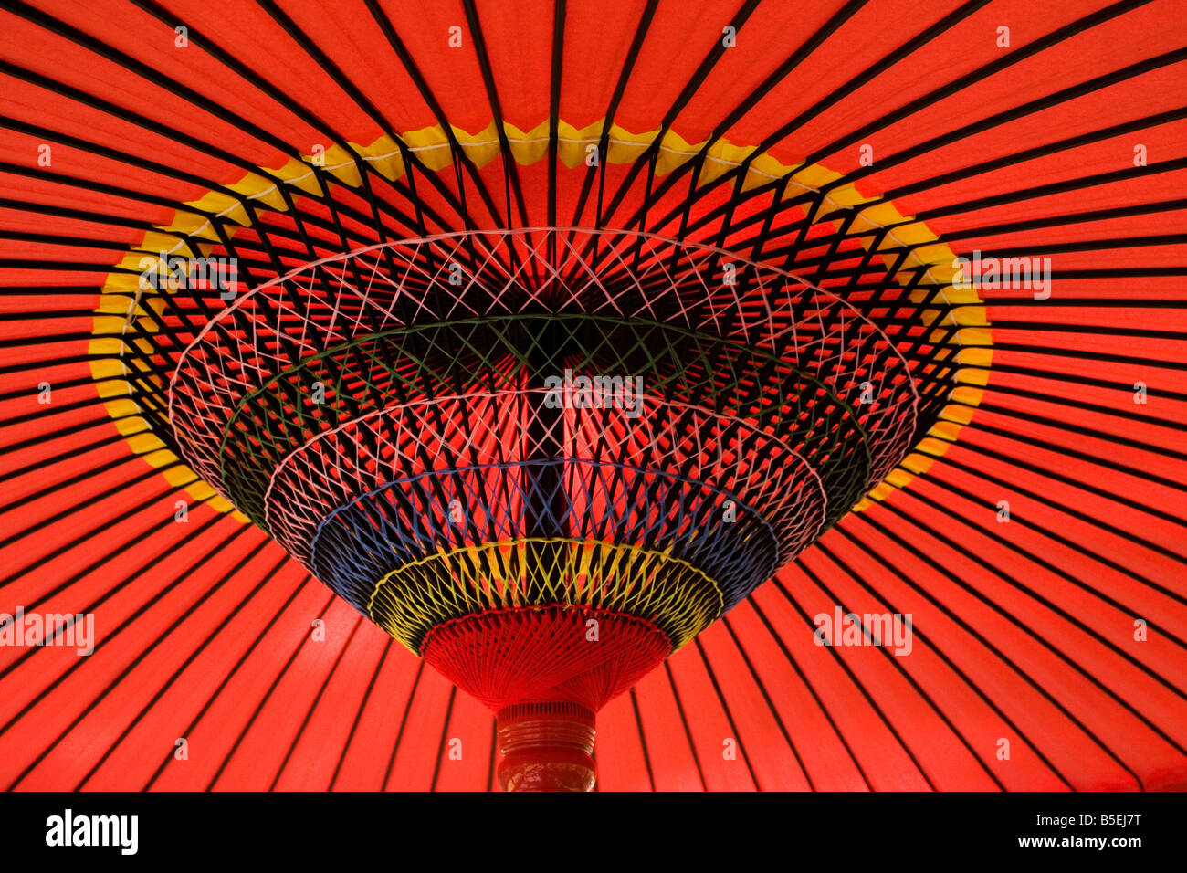 A traditional red Japanese umbrella is open in Kyoto, Japan Stock Photo