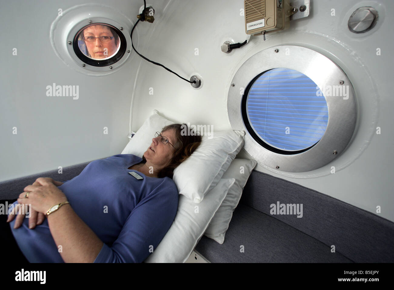 a nurse monitors a patient inside a decompression chamber at Mapua Health Centre near Nelson Stock Photo