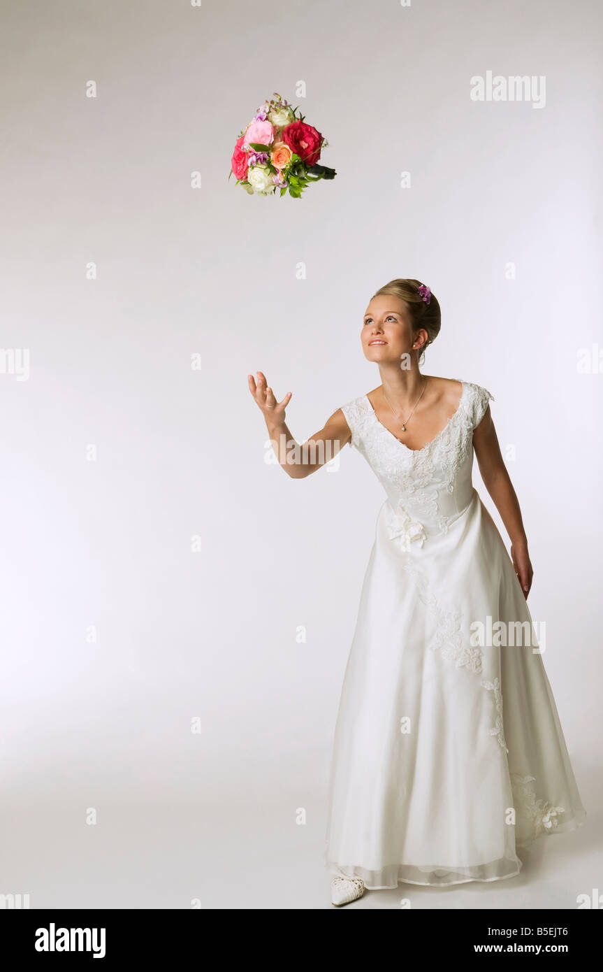 Young bride tossing bridal bouquet Stock Photo Alamy