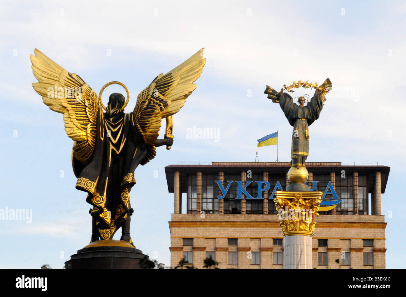 Sculpture of archangel Michael (L) facing a statue on a column in