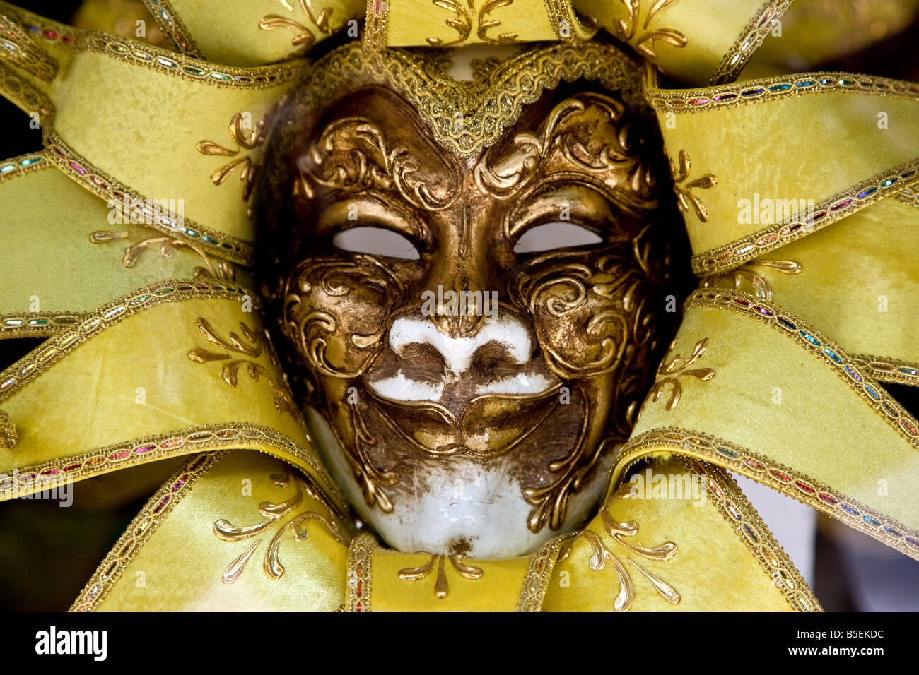 Venetian mask sun like in appearance with gold details Venice Veneto Italy Europe EU Stock Photo