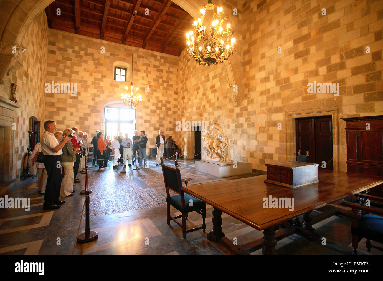 Tourists visiting one of the rooms in the Palace of Grand Masters of Rhodes, Greece Stock Photo