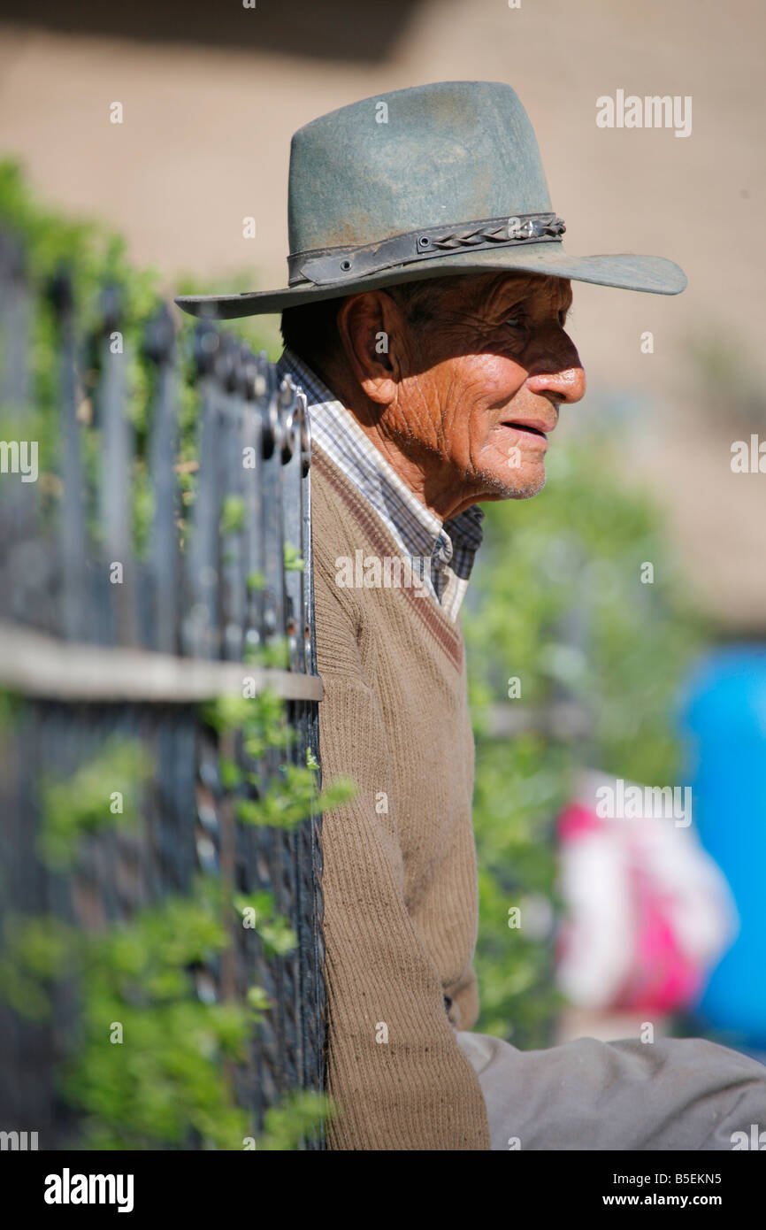 Man sitting in the main square of Cabanaconde Village Stock Photo