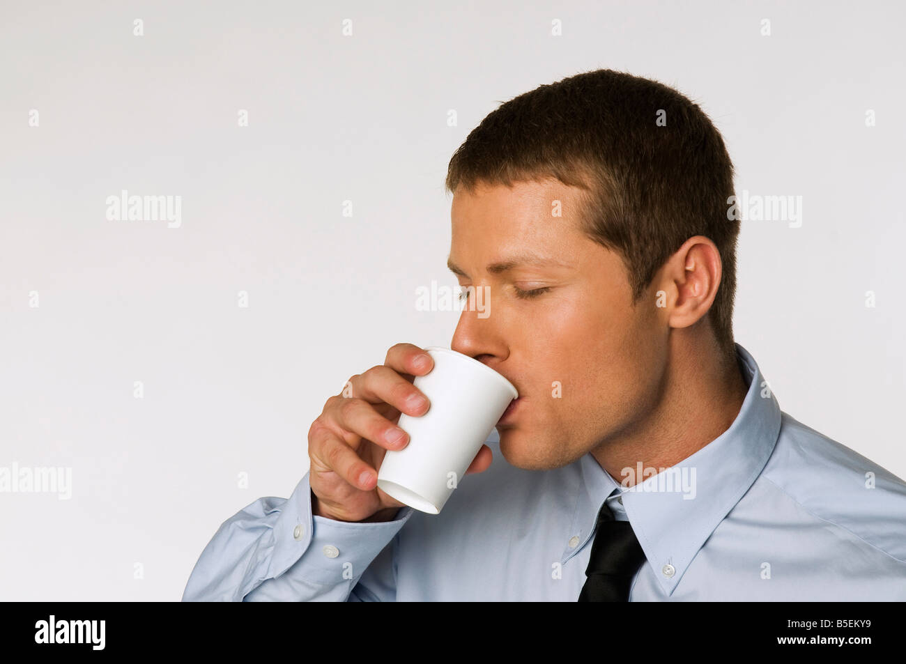 Businessman drinking cup of coffee, portrait Stock Photo Alamy