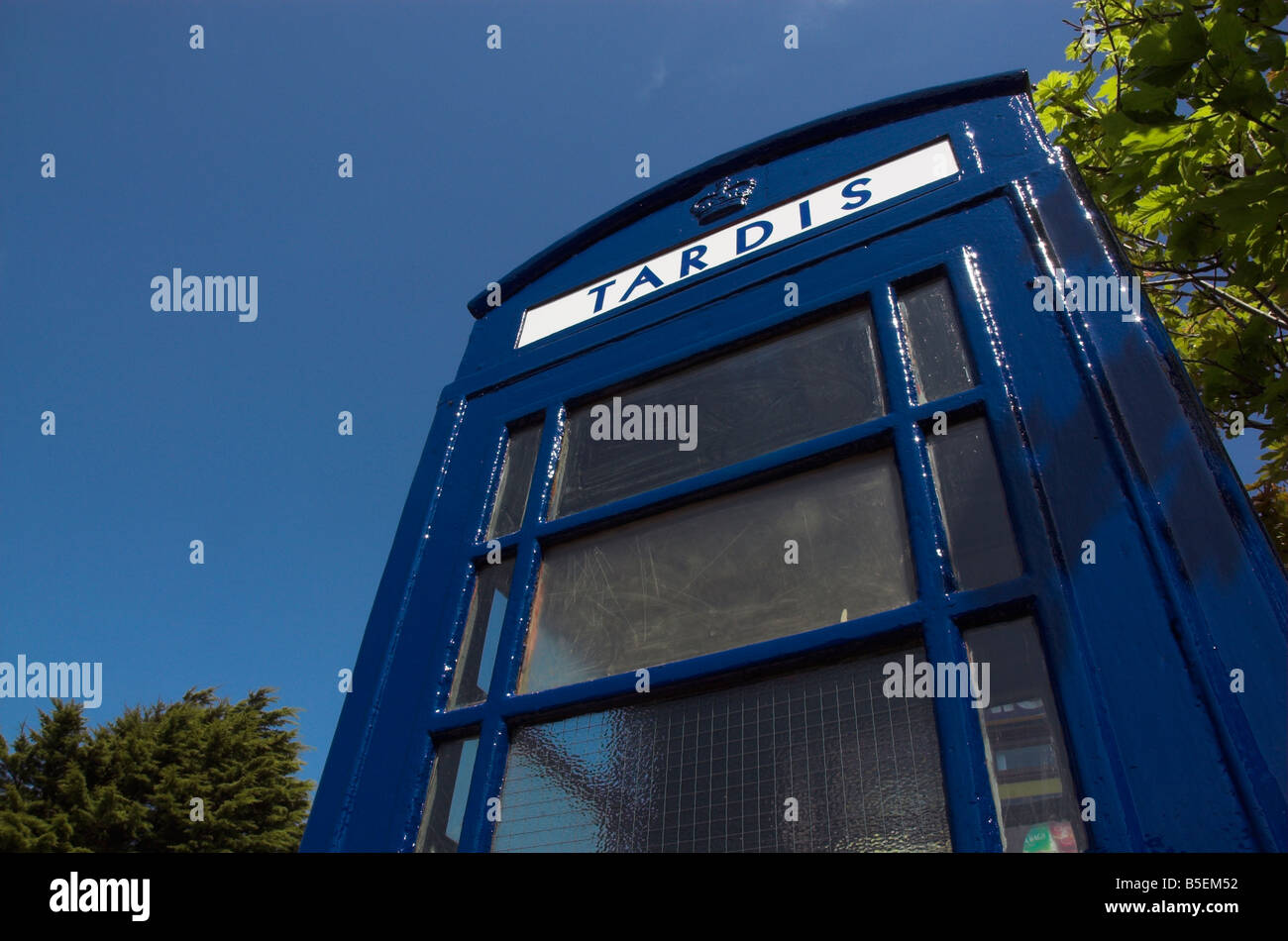 An old english telephone booth painted blue as a tardis Stock Photo