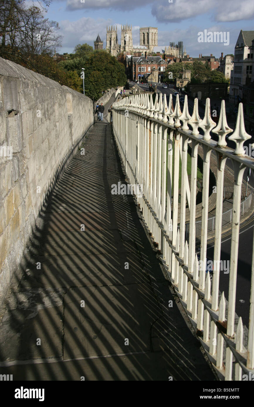 City of York, England. York City walls adjacent to Station Road with Lendal Bridge and York Minster in the background. Stock Photo