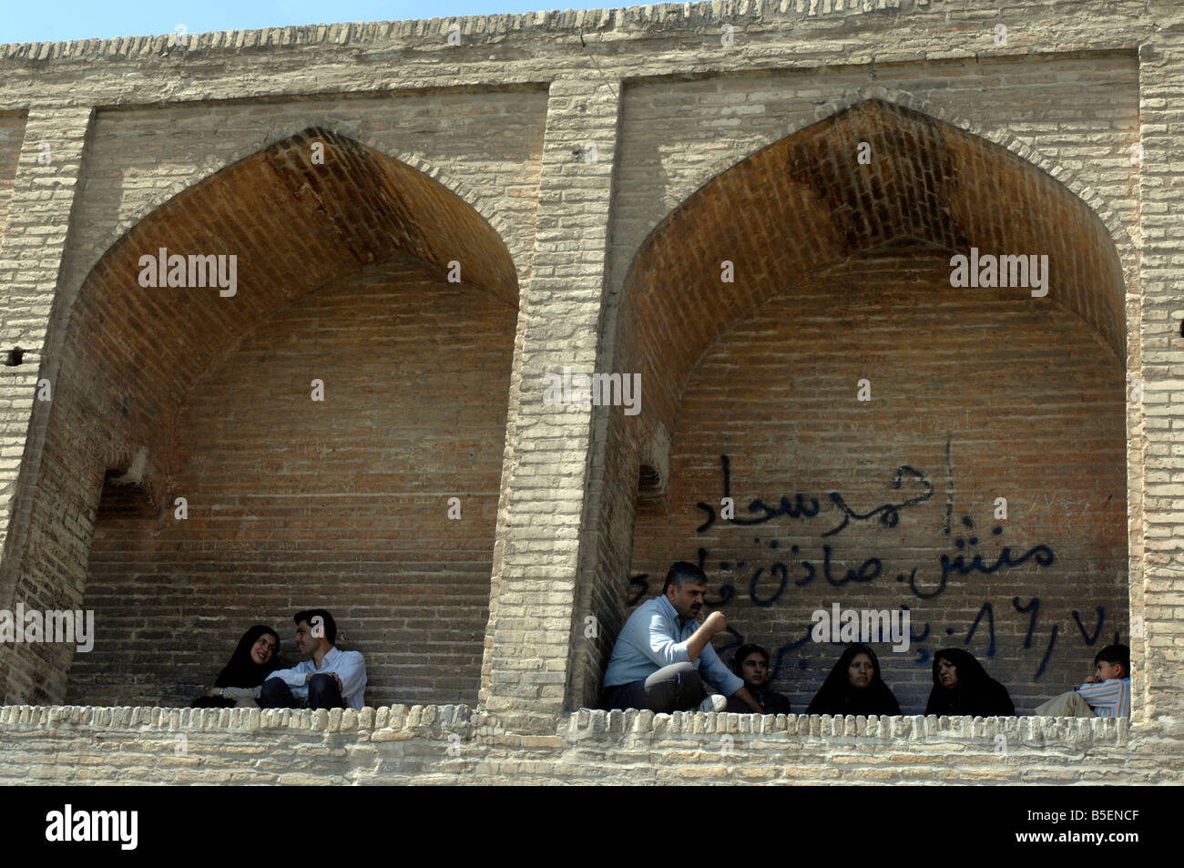 Iranians gather in the arches of the 298m Si-o-Seh Bridge, Esfahan Stock Photo