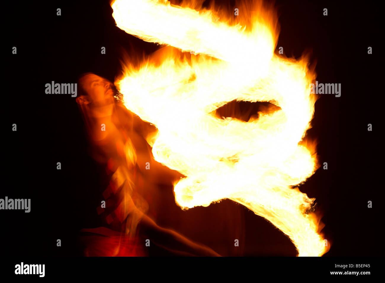 firepoise man performance artist displaying fire patterns with fire ...