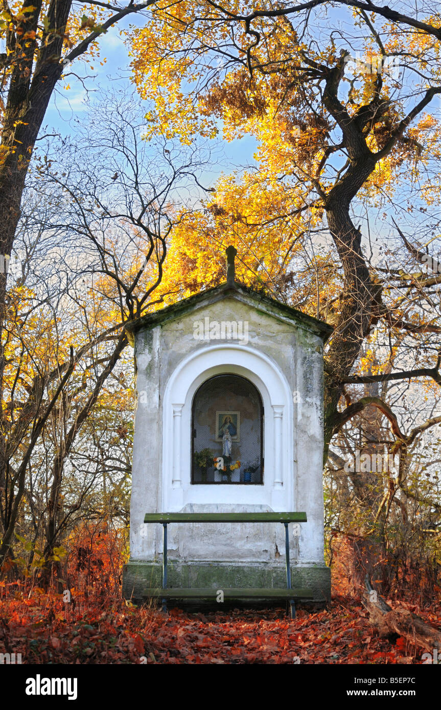 Old small chapel among autumn trees in the light of setting sun. Park of Kačina castle near Kutná Hora, Czech Republic. Stock Photo