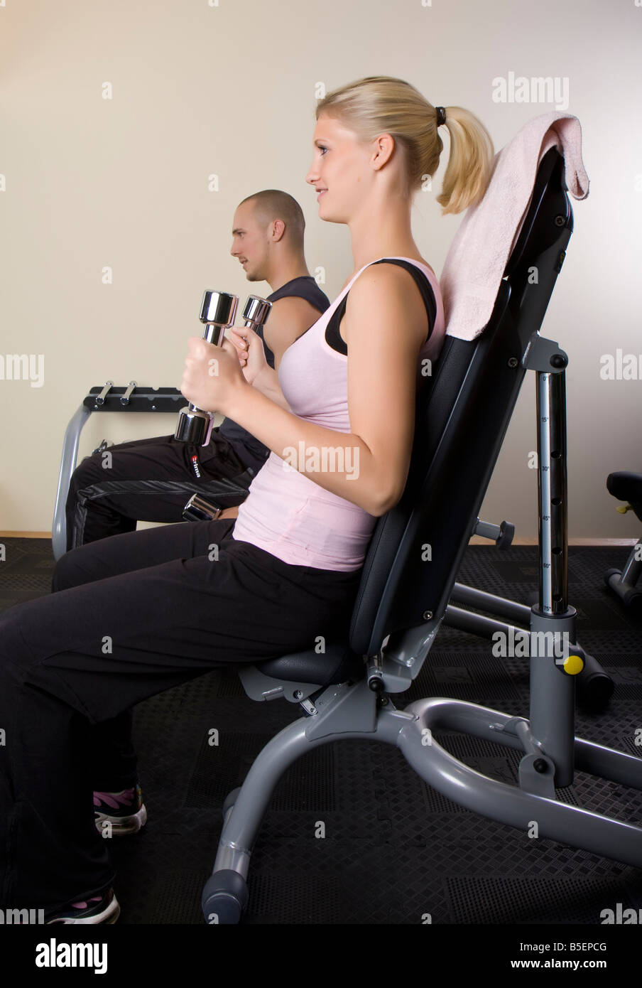 young woman and young man training with dumbbells Stock Photo - Alamy