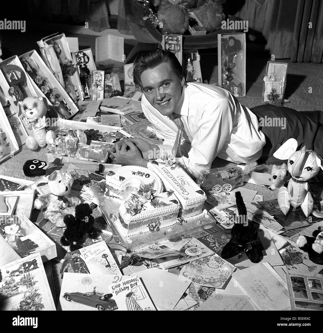 Billy Fury singer on his 21st birthday April 1962 laying on floor wityh birthday cake and cards Stock Photo