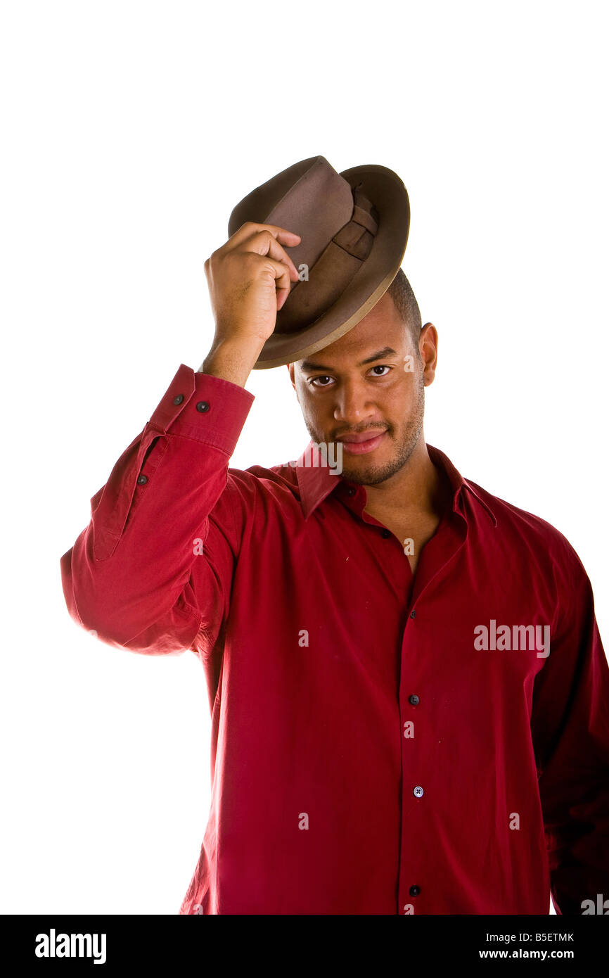 A black man dresses casually tipping a brown fedora Stock Photo - Alamy