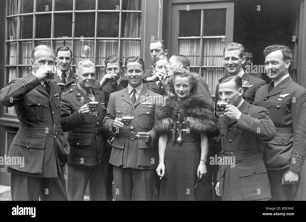 Members of 617 squadron toast Wing Commander Guy Gibson and Mrs Gibson after the investiture.&#13;&#10;June 23rd 1943. Stock Photo