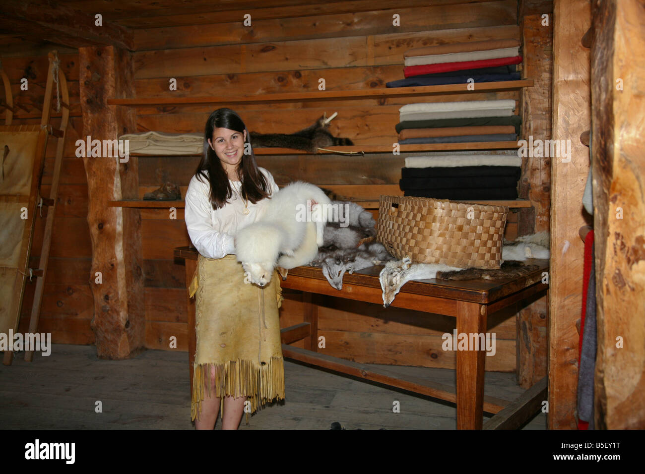 Native Indian Maiden with a collection of Furs at the authentic Indian Village Midand Ontario Canada Stock Photo