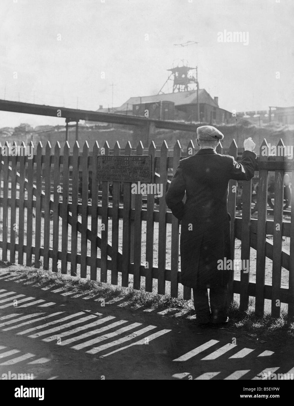 A miner looks over the fence toward the Gorkie Colliery during the miners strike in World War Two. ;The flagstaff at the top of Stock Photo