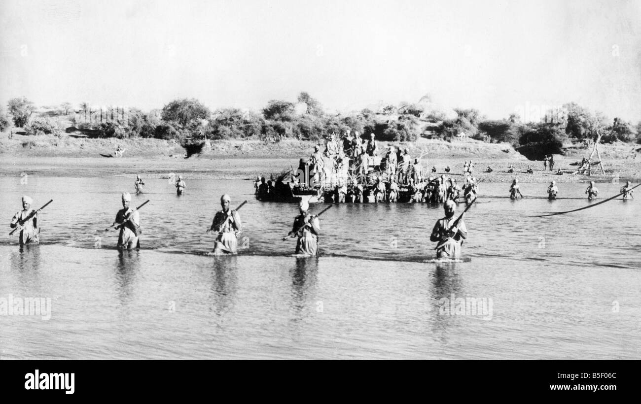 Soldiers from an Indian Infantry Brigade, holding advanced posts on the Eritrean frontier, cross the river Atbara. A pontoon conveys the M.T while the men wade across.;16th December 1940. Stock Photo