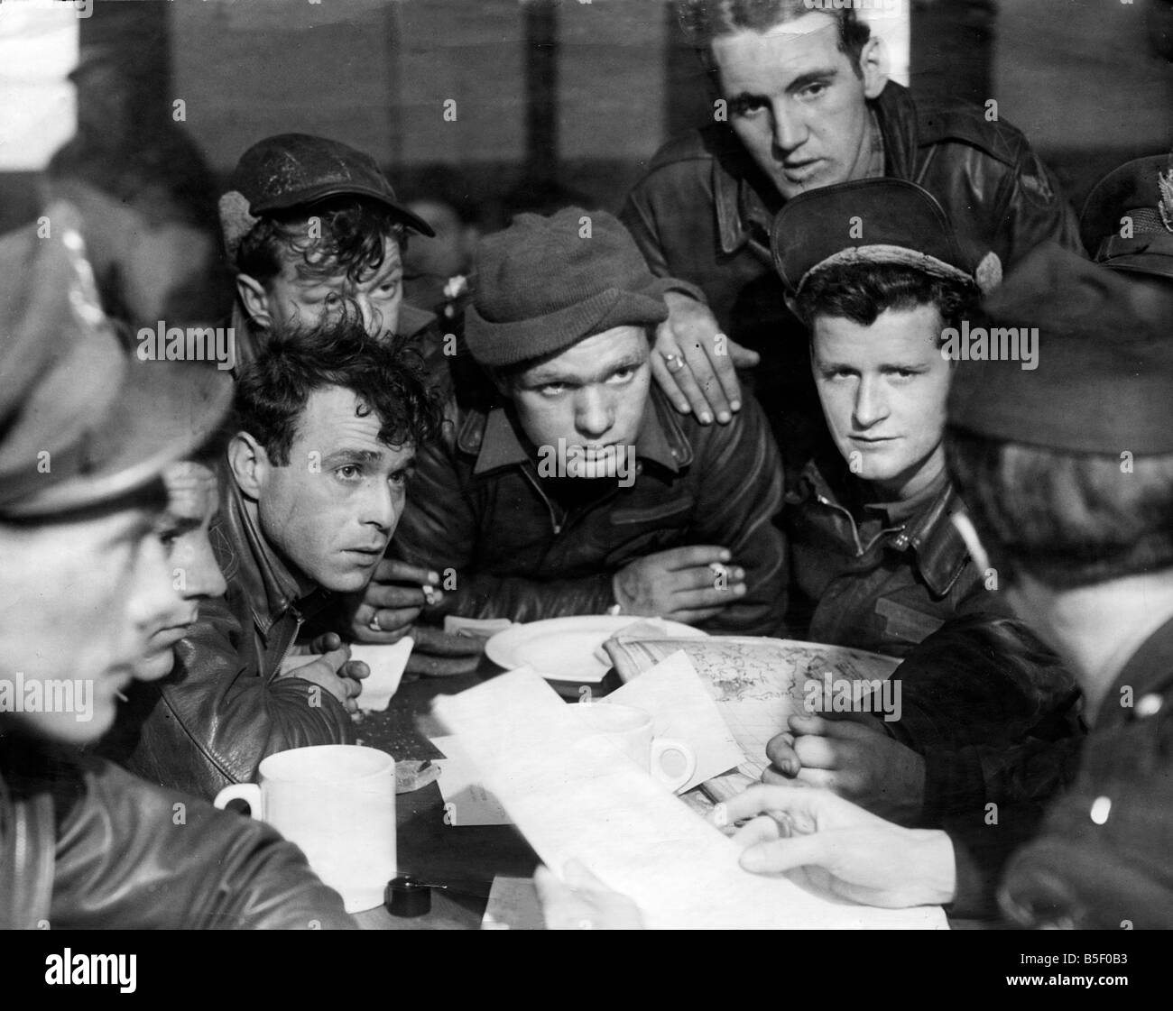 Pilots of the American 8th Air Force being debriefed by an Intelligence Officer following a daylight raid on occupied France during the Second World War in preparation for D Day March 1944 Stock Photo