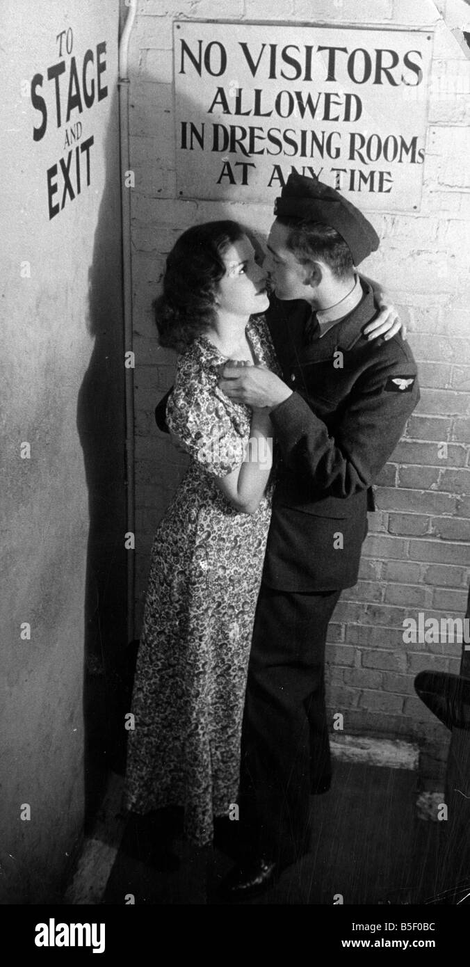 A windmill girl kisses her boyfriend a pilot in the RAF backstage at the Windmill Theatre during the Second World War September Stock Photo