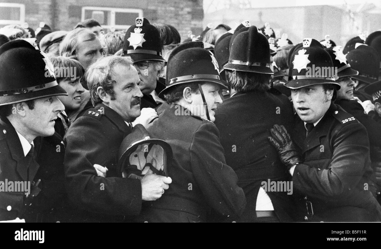 A group of police officers hold back a crowd circa 01 06 84 Stock Photo ...