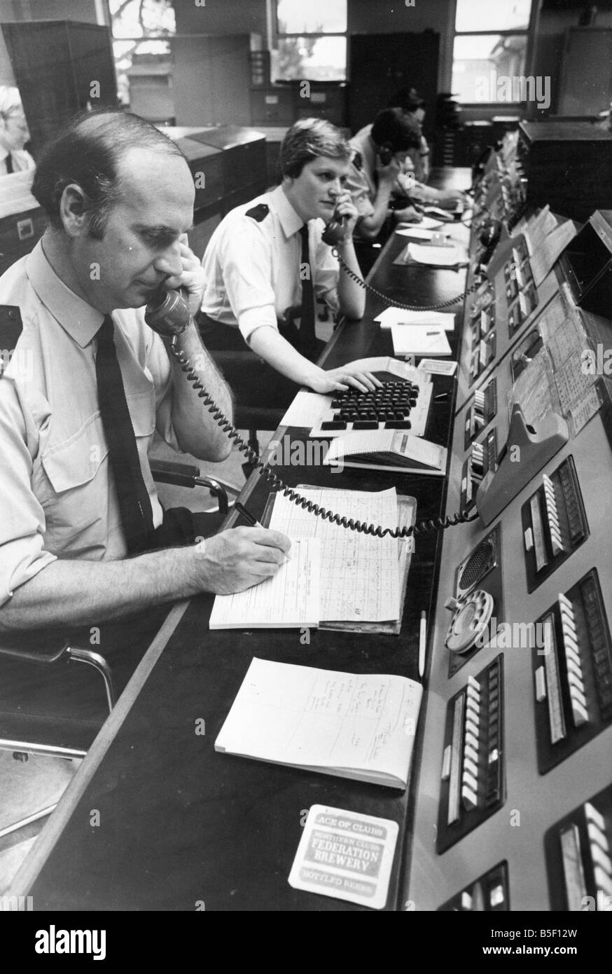 All hands on deck police officers in the control room cope with a flood of 999 phone calls Stock Photo