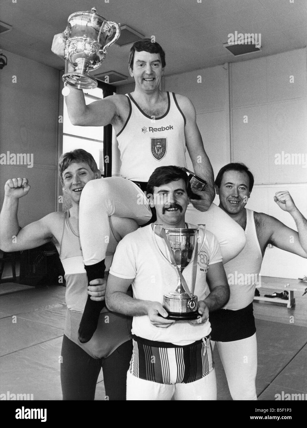 The Northumbria Police wrestling team left to right police officers Neville Hedley Dave Peart John Stevenson and Chris Palmer celebrate winning medals at the National Police Wrestling Championships Stock Photo