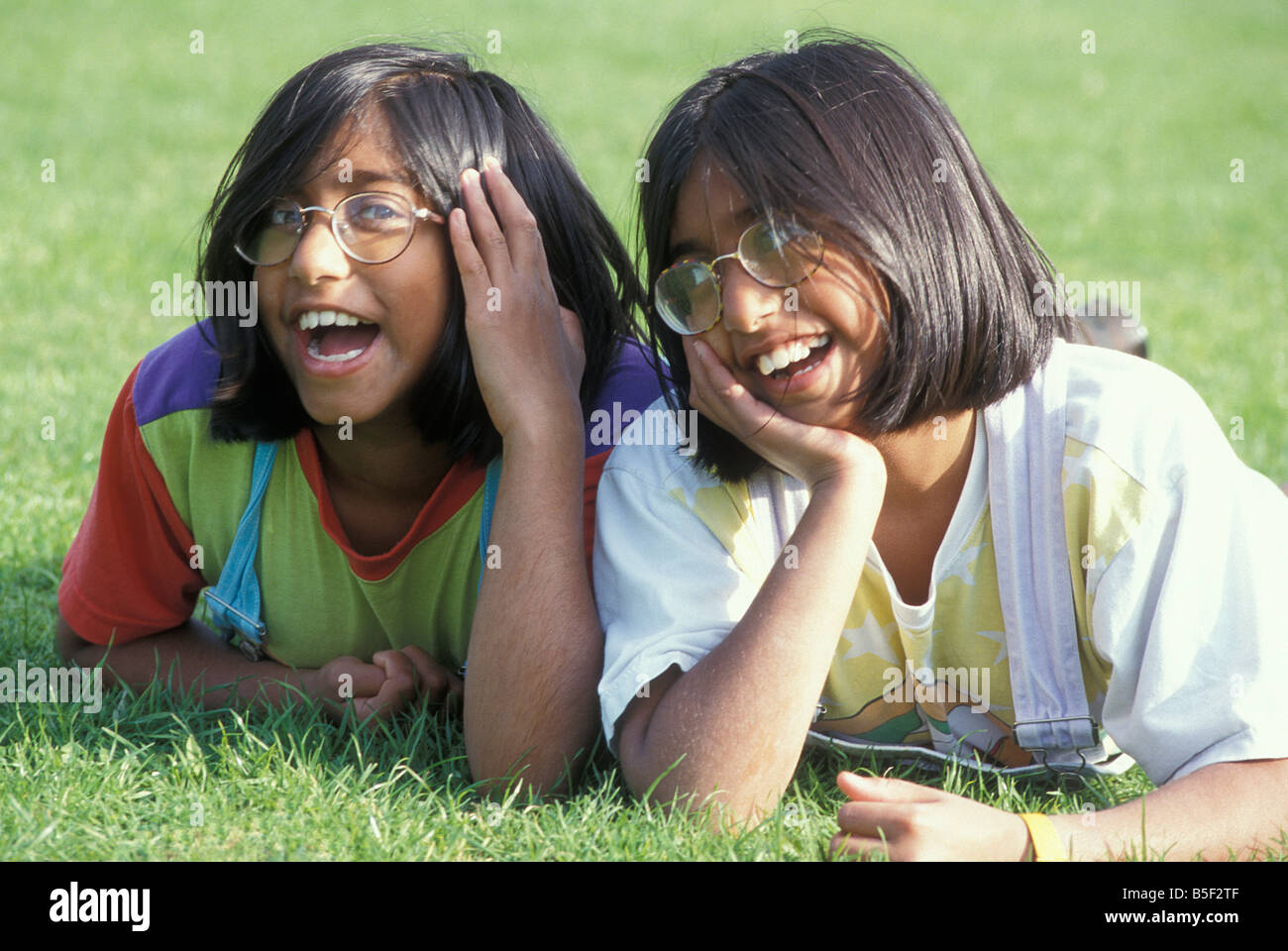 portrait Asian twin girls wearing glasses Stock Photo
