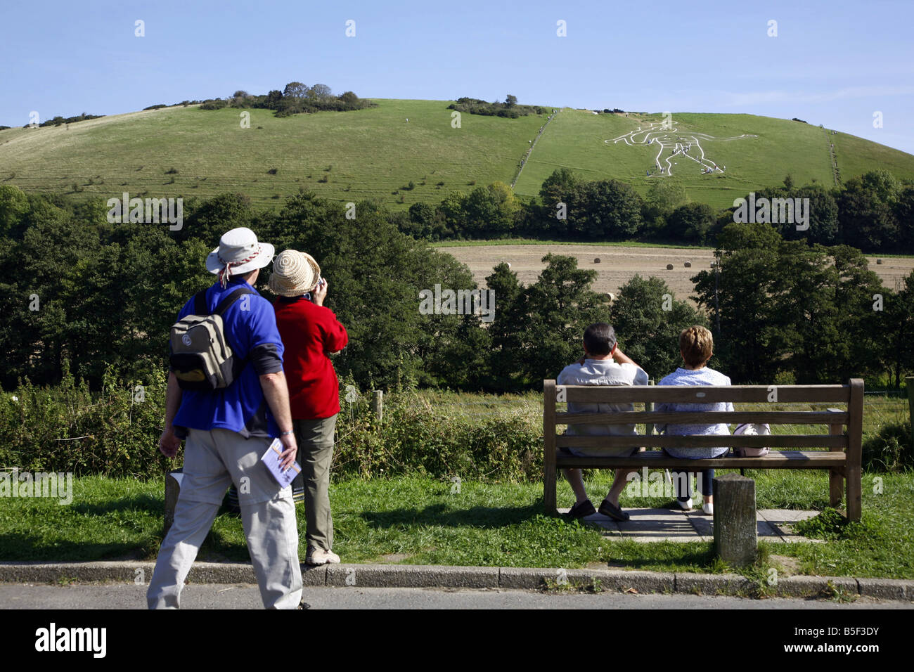 Visitors view the restoration work being carried out restoring the Cerne Abbas Giant to its former glory Stock Photo