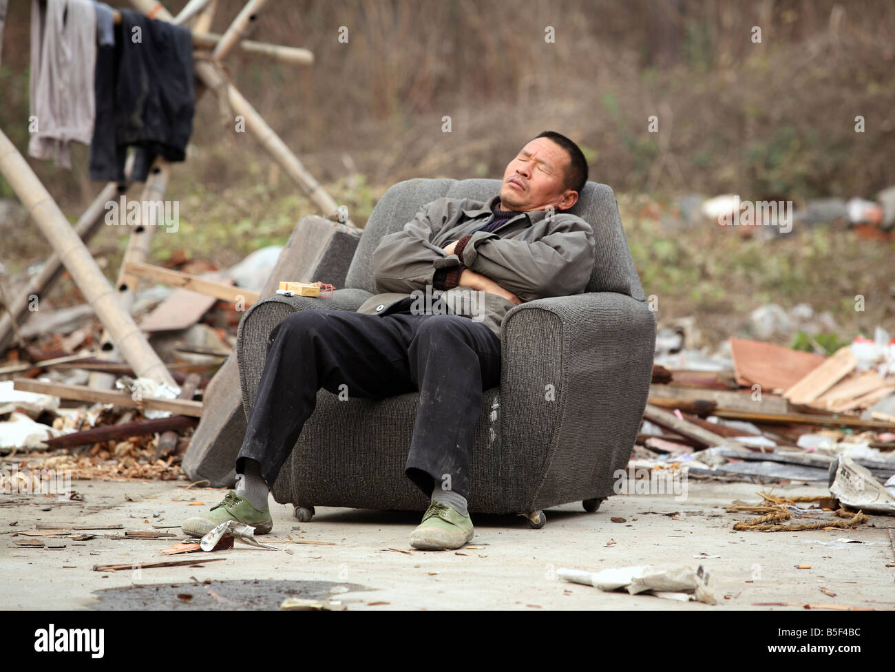 An Asian man sleeping in a chair, Suzhou, China Stock Photo