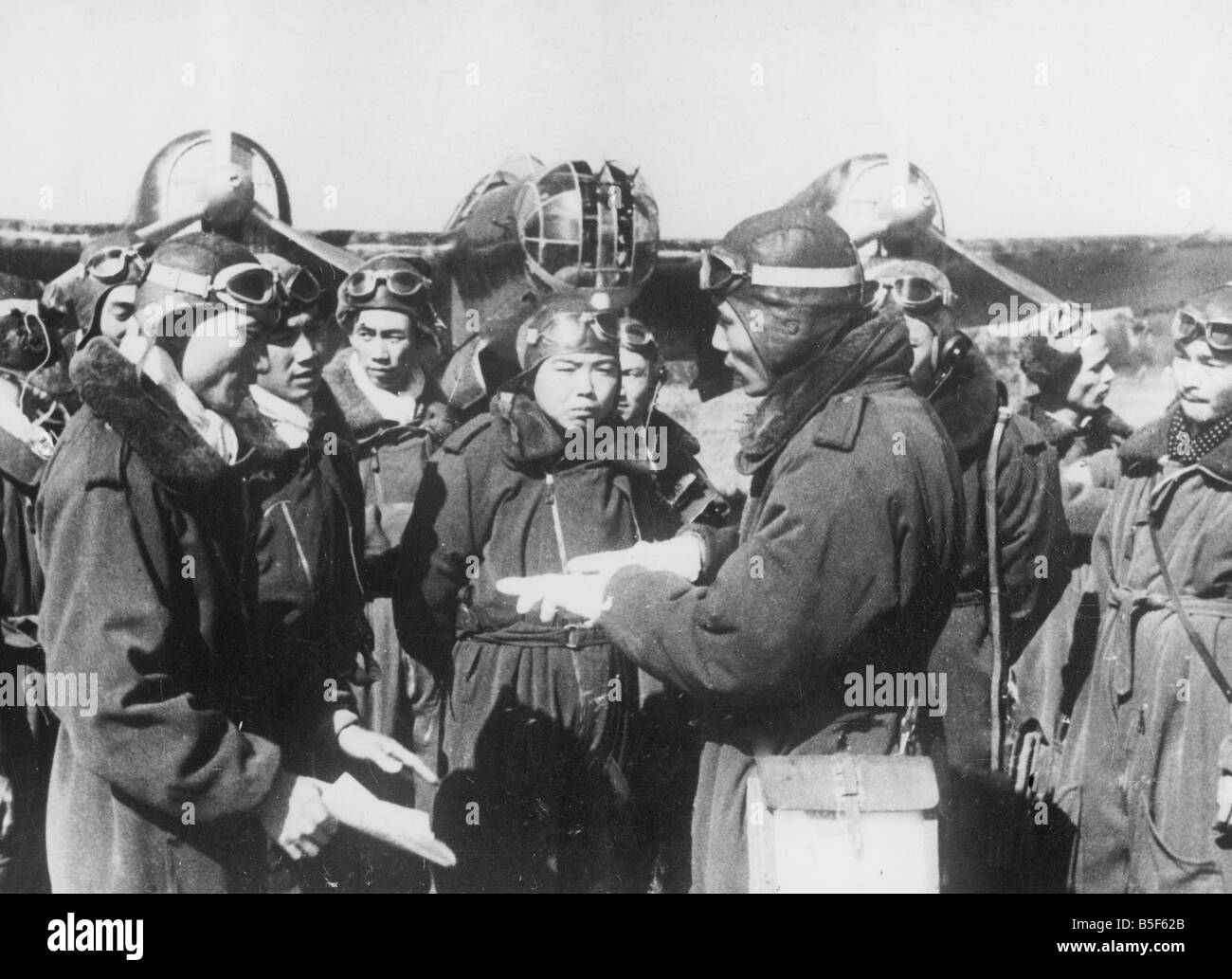 Pilots of the Chinese Air Force receive instructions from officers before taking off for a mission at an Air Force base in China during the Second World War. ;December 1943 Stock Photo