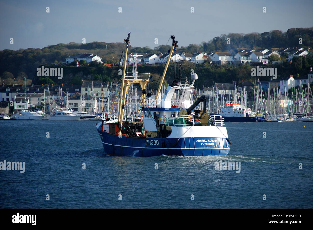 Fishing boat returning to harbour Stock Photo - Alamy