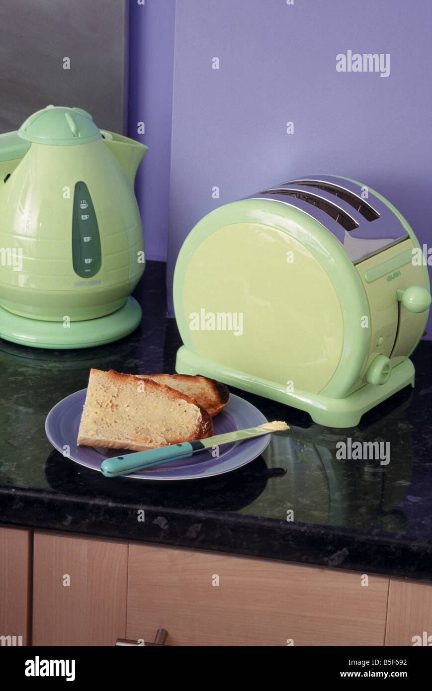 Closeup of pale green electric kettle and toaster on worktop below