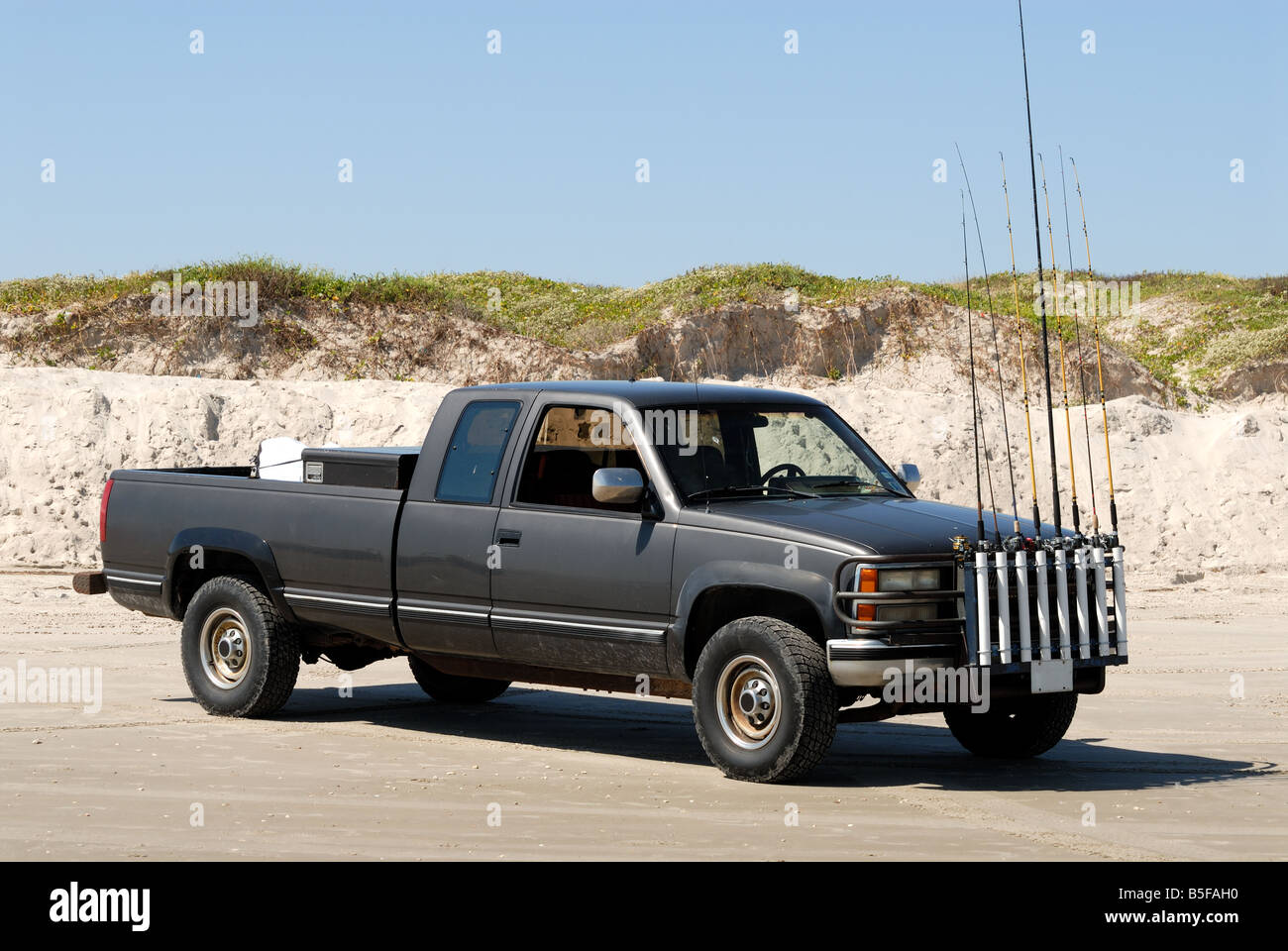 Two men unloading fishing poles and equipment from bed of a red pickup truck  parked at the boat ramp and dock near Yankeetown Stock Photo - Alamy