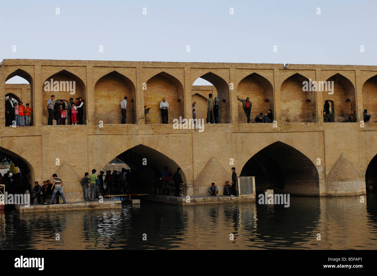 No Ruz holiday makers in the arches of the 298m Si-o-Seh Bridge, Esfahan Stock Photo