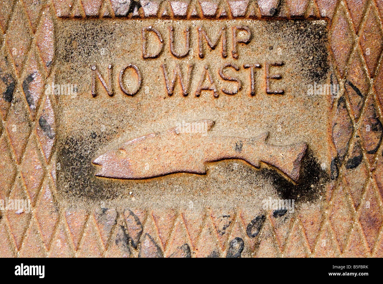 Dump No Waste sign on sidewalk Stock Photo