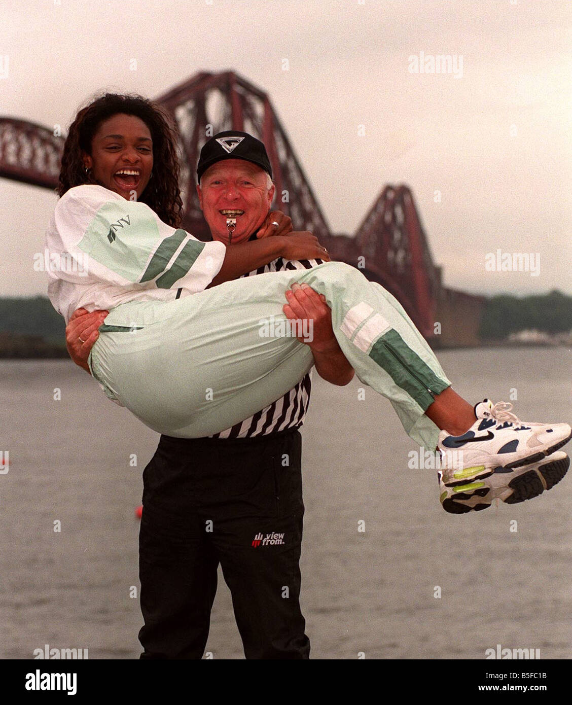 Gladiators referee John Anderson gives a lift to Gladiator Rocket (Pauline  Richards) with the Forth Railway Bridge in the background Stock Photo -  Alamy
