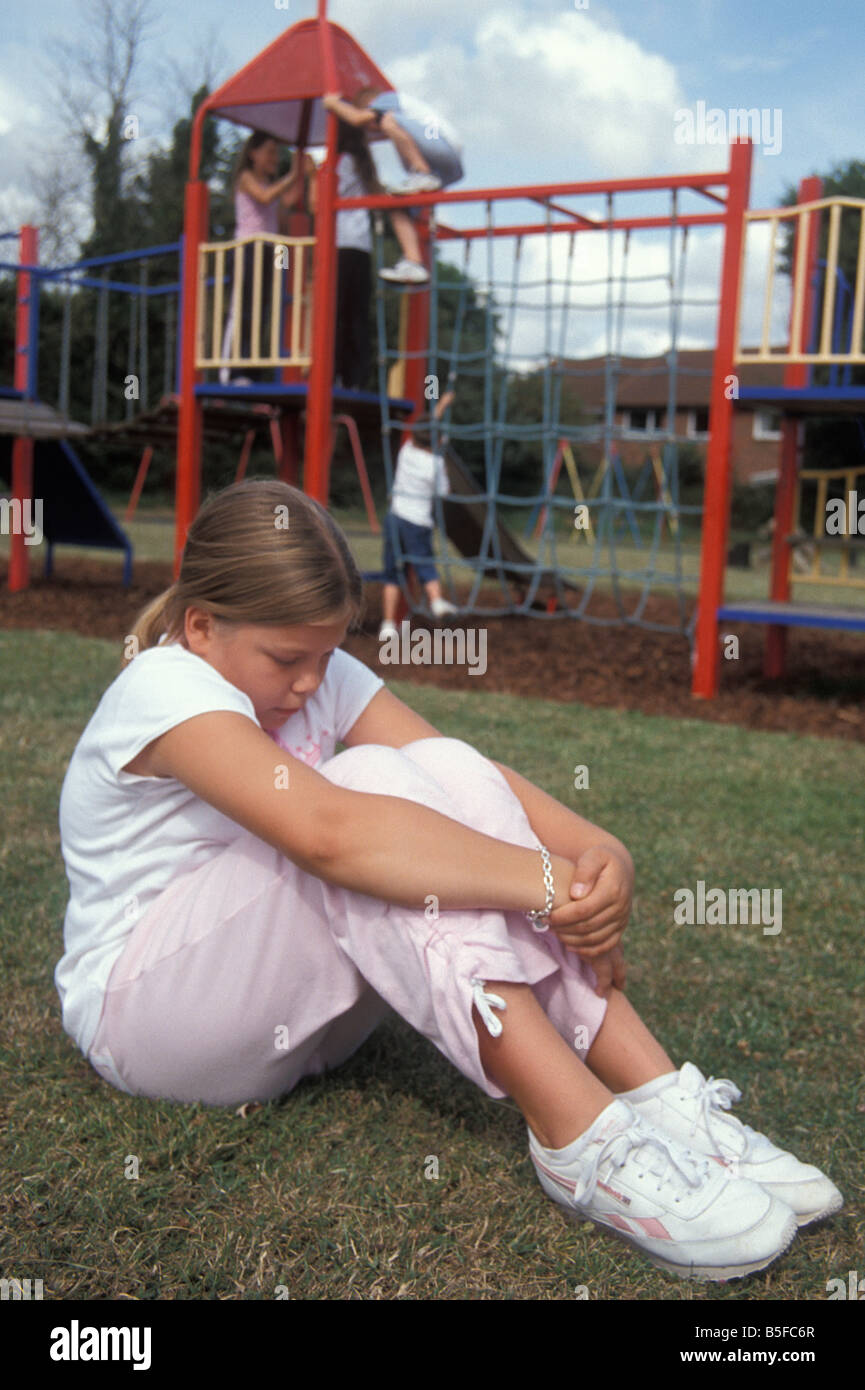 young girl in playground feeling left out Stock Photo