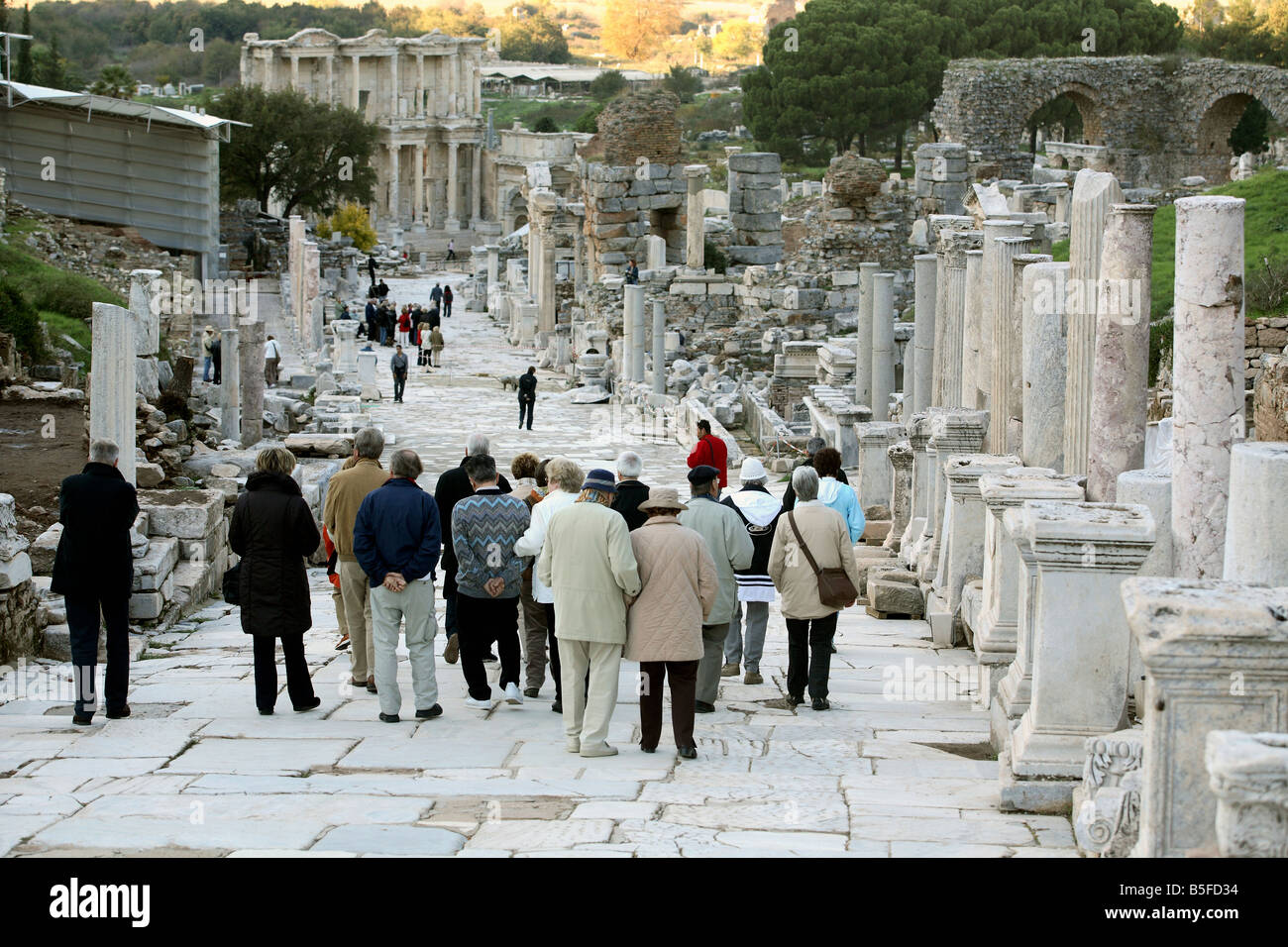 Tourists visiting the ruins in the Curetes Street in Ephesus, Turkey Stock Photo