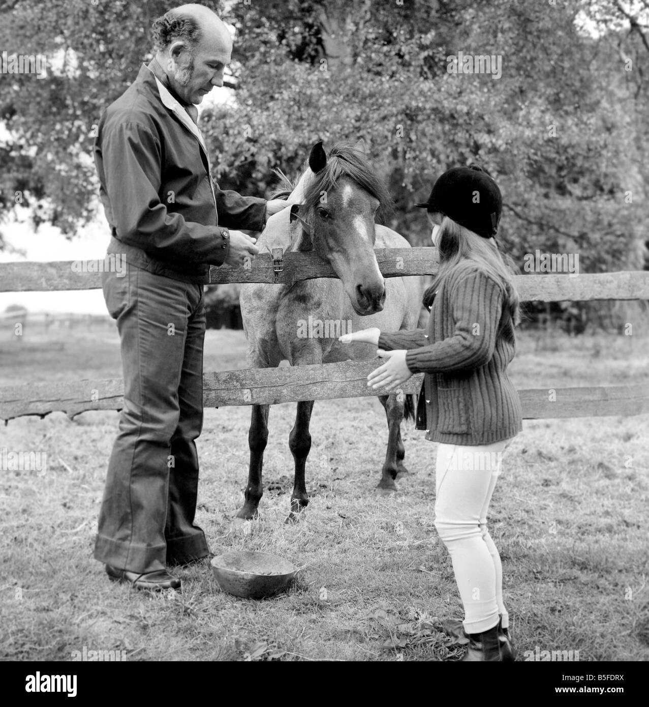 Sterling Moss (Ex Racing Driver). Seen here with horse and daughter. June 1974 S74-3861-001 Stock Photo